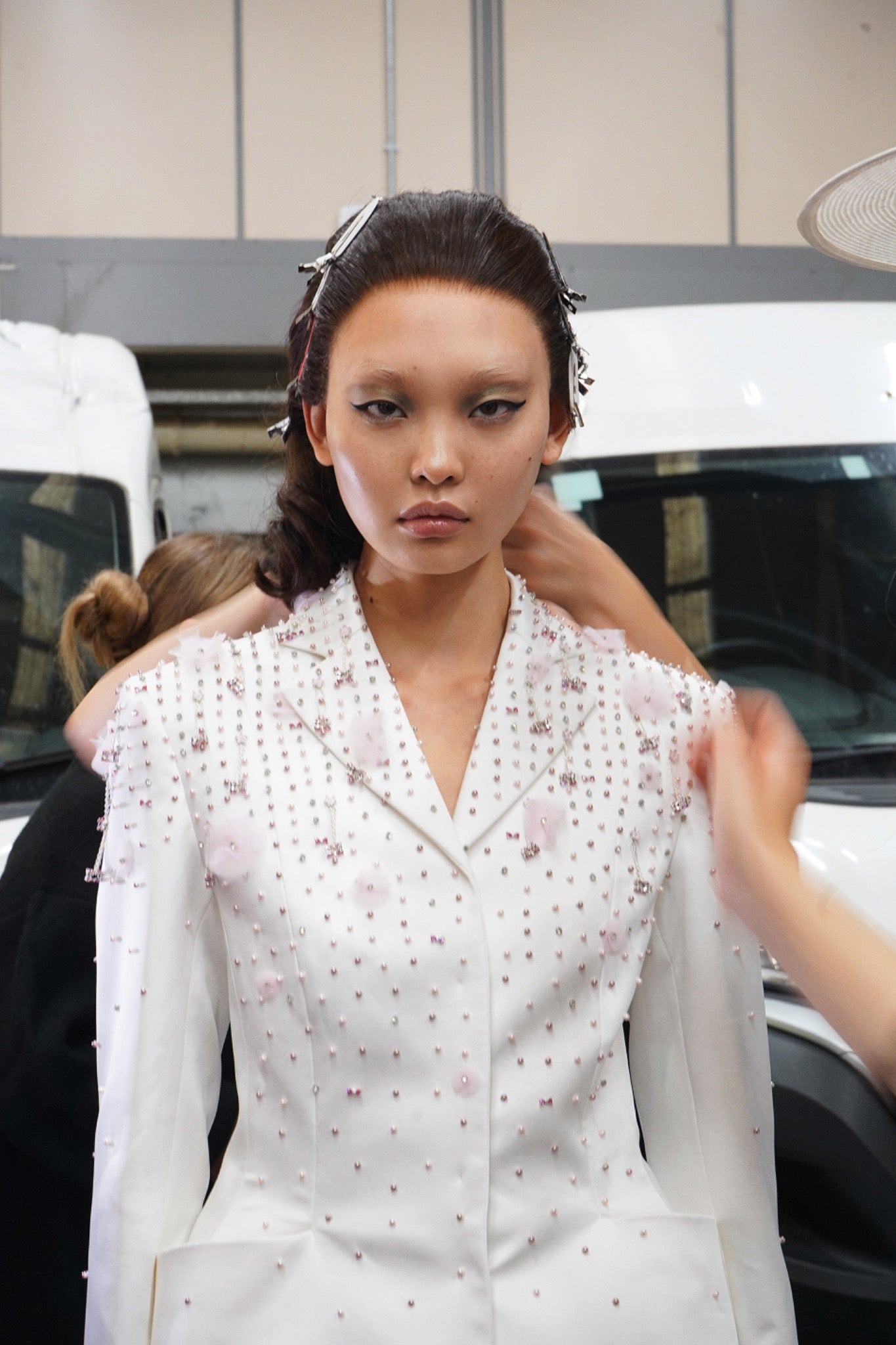 Model backstage wearing a bespoke brunette BLB wig for Patrick McDowell Spring Summer 2027.